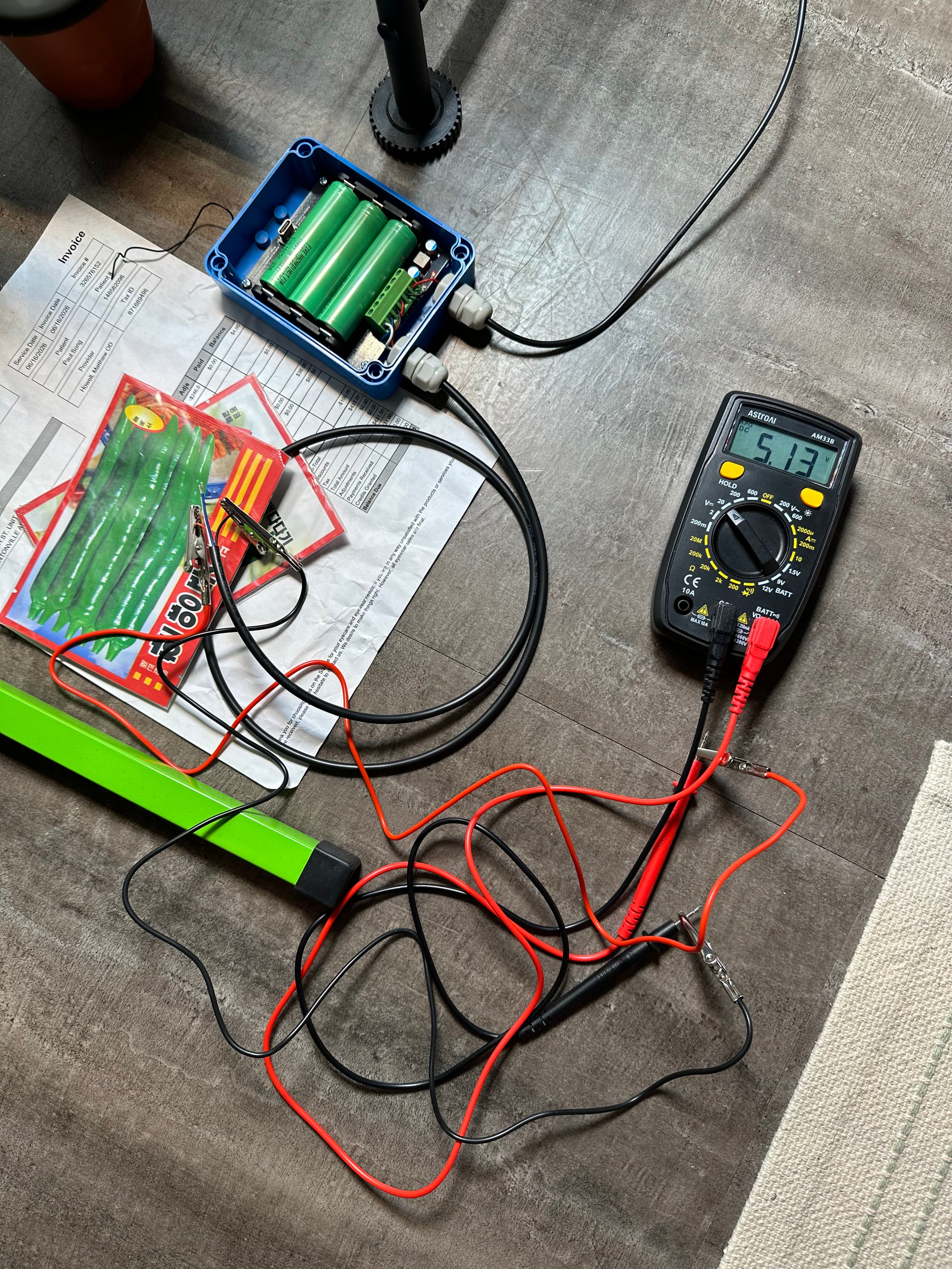Multimeter reads 5.17 V off the pack — confirming a regulated source.
