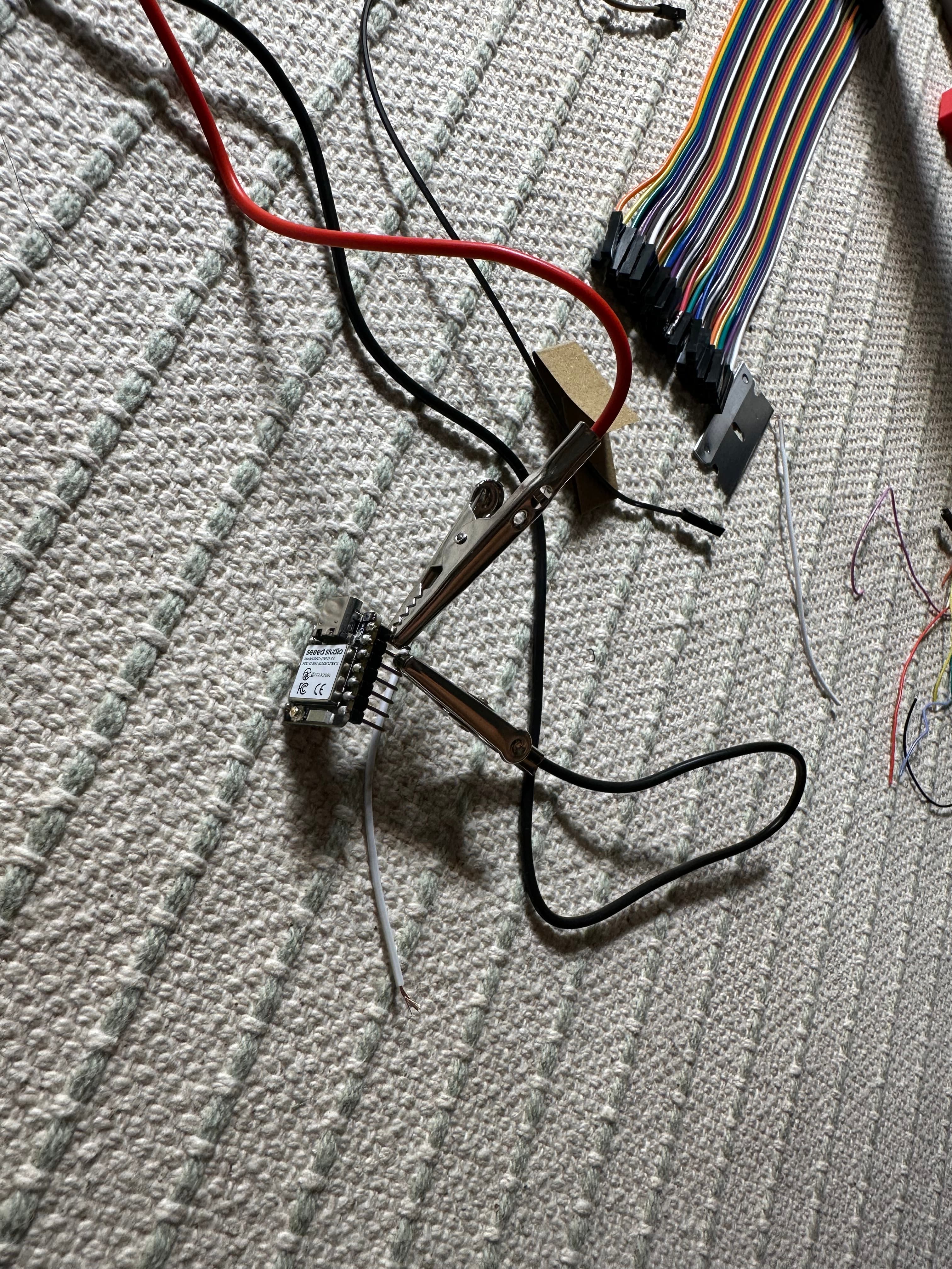 Wiring on the floor: a board in helping-hands, jumpers fanning out.
